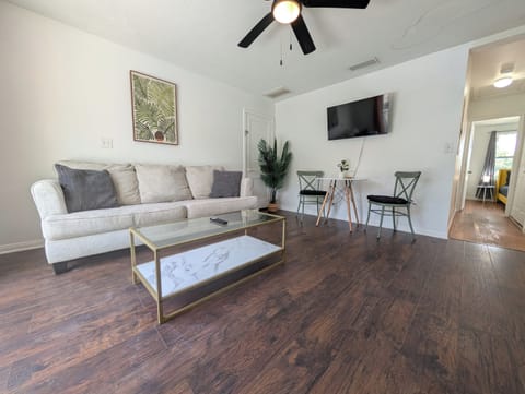 Comfortable living room with smart TV and breakfast table
