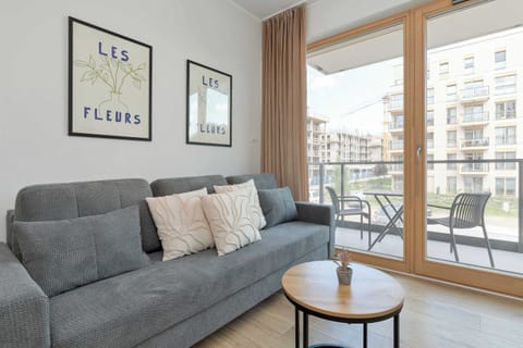 Bright and modern living area with comfortable seating and direct access to the balcony.