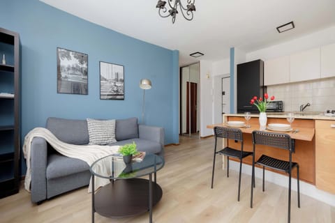 Contemporary living space with a blue accent wall, comfortable seating, and an integrated dining area.
