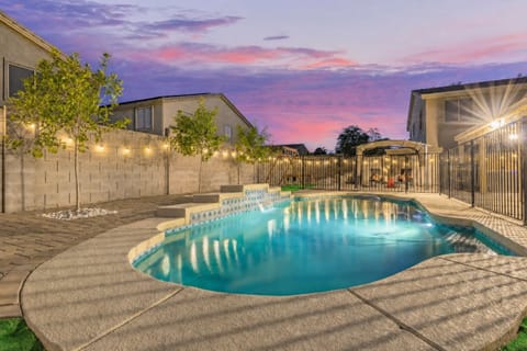 Enjoy Arizona evenings under the stars with a beautifully lit backyard designed for relaxation and family fun.