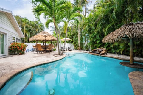 A tropical paradise with a private pool surrounded by lush palms and thatched umbrellas. Lounge on sunbeds, dine alfresco, or cool off in crystal-clear waters.