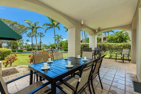 Savor morning coffee or meals at your private covered lanai overlooking lush tropical gardens and swaying palms—perfect for enjoying warm island breezes and peaceful resort views.