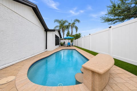 Private swimming pool surrounded by a fully fenced backyard, perfect for cooling off and enjoying sunny Florida days in complete privacy.