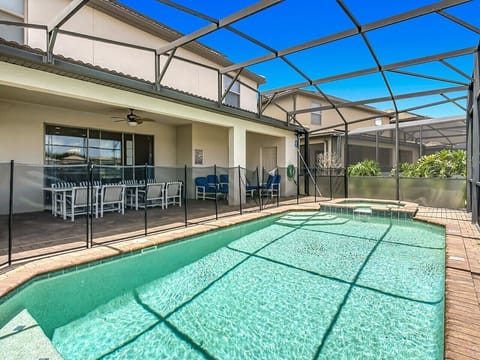Screened pool area with covered patio seating.