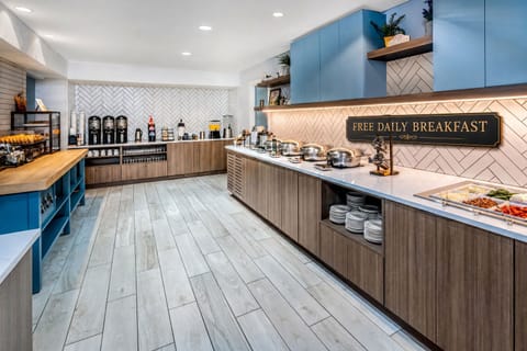 Hot and cold breakfast options laid out daily — eggs, pastries, fruit, and coffee all included
