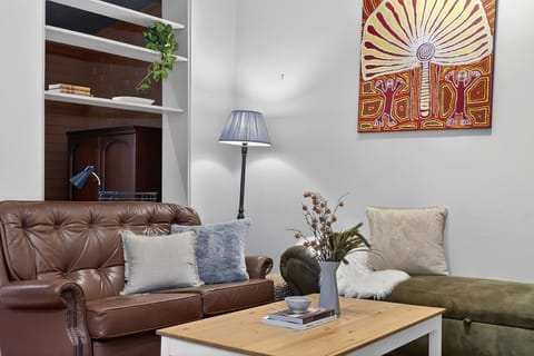 Leather sofa lounge with Indigenous artwork & built-in shelves