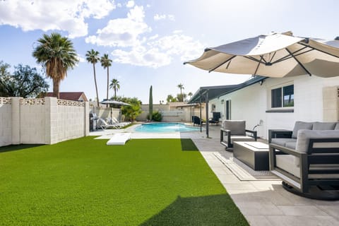 Spacious backyard with outdoor seating, lush turf, and plenty of room to relax and enjoy the sunshine.