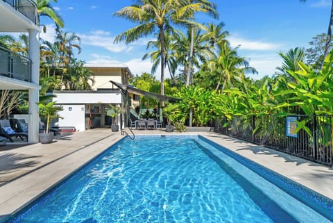 Cool off in the sparkling shared pool surrounded by lush tropical gardens and swaying palms.