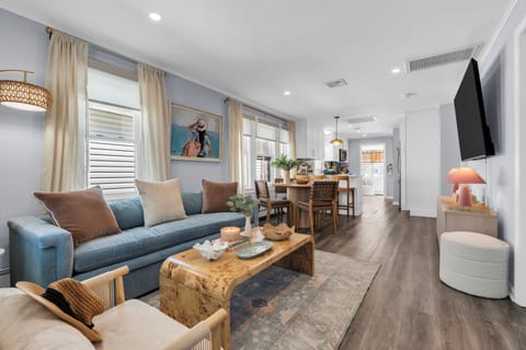 Bright open-plan lounge and dining space with stylish coastal-inspired decor