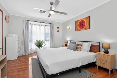 Retreat to the primary bedroom, where a king bed, calming tones and abundant natural light create a restful setting for slow mornings and peaceful nights.