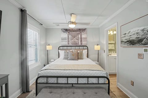 Rest easy in this inviting bedroom with thoughtfully chosen décor, including a beautiful under-the-pier-inspired piece above the bed!
