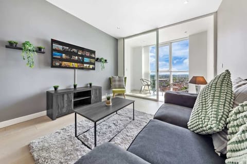 Unwind in this stylish, light-filled apartment featuring a sleek living space, smart TV, and cozy balcony perfect for morning coffee or evening relaxation. Enjoy contemporary furnishings, lush greenery accents, and floor-to-ceiling windows with b... | Photo tags: Property exterior
