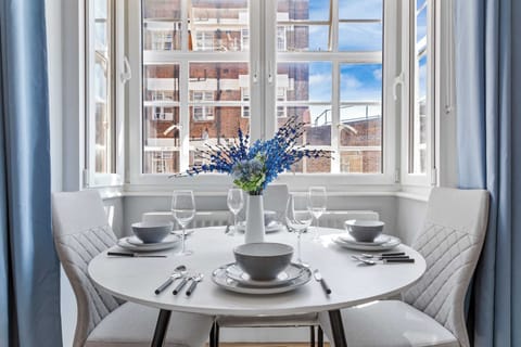 Cozy breakfast corner to enjoy your morning meal with abundant natural light and a pleasant outdoor view.