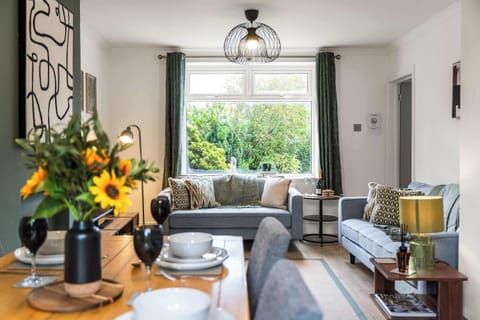 The cozy living room features 2 comfy sofas to relax on, with a SMART TV and plenty of soft furnishings to feel right at home during your stay.