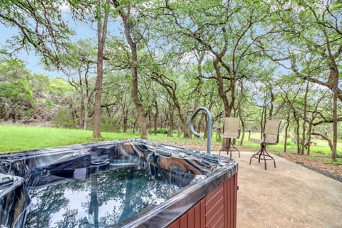 Soak in the private hot tub surrounded by towering trees