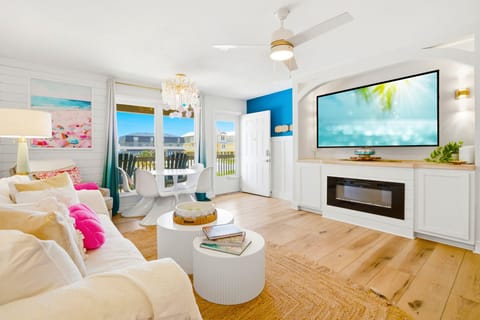 North Lost Key Landing B2- Step into your bright coastal haven, where soft whites meet ocean blues and sunshine streams through French doors. Sink into the plush seating, feel the warmth of natural wood beneath your feet.