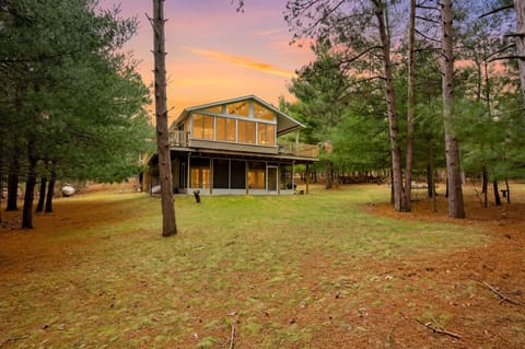 Private forest retreat with soaring windows, deck, and serene open yard