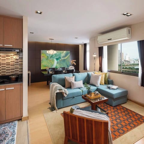 【Living room】Greenery View Overlooking Benchakitti Park, this space features an L-shaped sofa bed, Smart TV, and adjustable lighting to set the mood for family time.