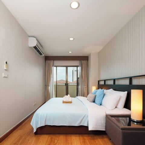 Bedroom with king-size bed, solid wall separation from the living room, and dual bedside outlets for continuous connectivity.