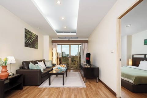 Spacious living room with an open layout and a balcony overlooking Bangkok city. Plenty of room to relax, move around, and feel right at home.