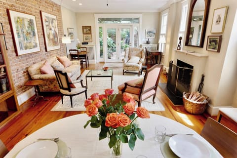 Relax in this beautifully appointed living room featuring exposed brick, hardwood floors, and abundant natural light.