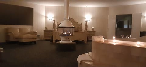 Unwind by the glowing fireplace in a sprawling luxury suite.
