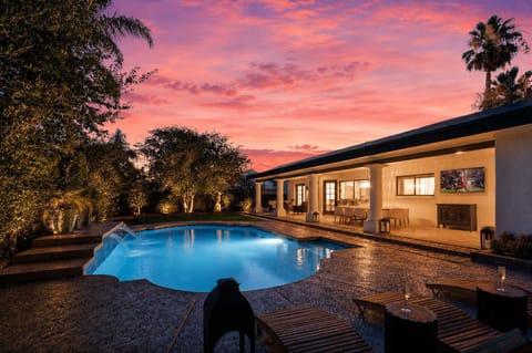 Private backyard oasis featuring a sparkling pool, BBQ grill, covered outdoor lounge, alfresco dining area, and poolside loungers, creating the perfect setting for sunny afternoons or evening gatherings.