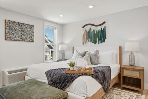 Cozy, modern bedroom with elegant boho accents, crisp linens, and a dedicated breakfast tray for a perfect morning in.