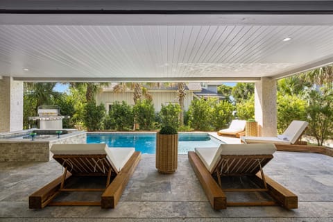 Multiple seating areas include 4 sun loungers and two comfy chairs