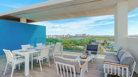 Rooftop terrace overlooking scenic golf courses and cityscape in the distance—perfect for outdoor dining and relaxation near the property.
