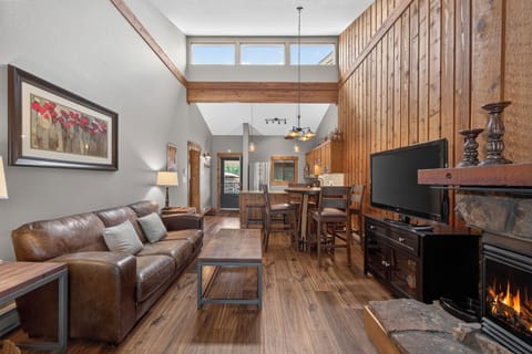 Sink into the plush leather sofa and feel the warmth of your private fireplace as natural light floods through soaring windows. This open-concept retreat blends rustic wood charm with modern comfort for your perfect mountain getaway.