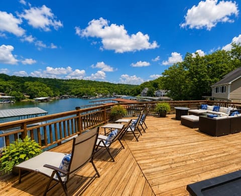 Spacious lakefront deck with stunning panoramic water views, perfect for relaxing, dining, and unforgettable sunset moments.