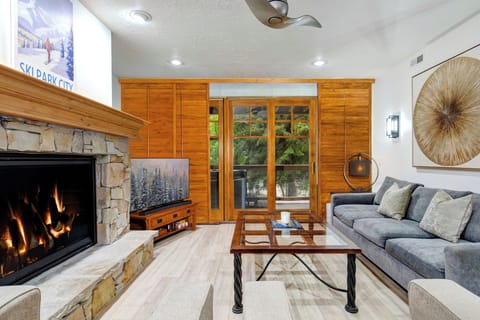 Relax in your stylish living room with a gas burning fireplace and mountain views through glass doors.