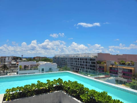 Shared rooftop pool available year-round with stunning Playa del Carmen views