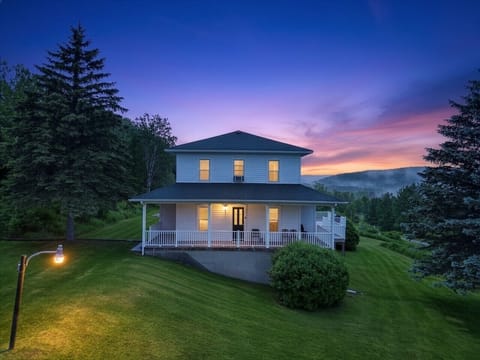 House Exterior | Covered Porch | Sunset Sky & Lawn Views