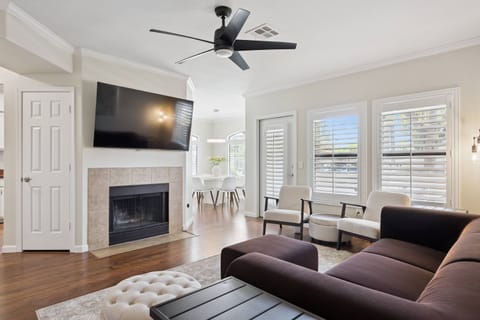 Cozy living room with Sofa, 55" Smart TV w/ cable and 2 chairs and direct access to the back patio