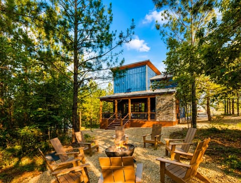 Wooded cabin retreat with front porch and cozy fire pit seating