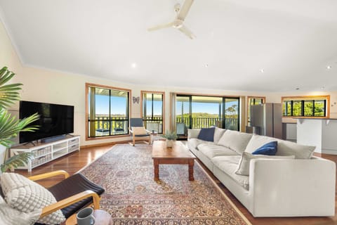 Sink into the generous lounge as natural light pours through expansive windows, with a smart TV, split-system air conditioning and sweeping countryside views creating an inviting setting for slow afternoons and cosy evenings together.