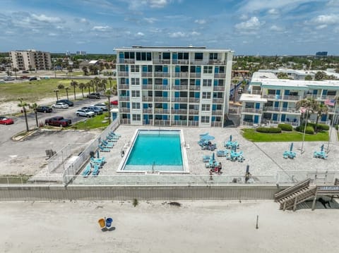 Beachfront building with one of the community pools overlooking the beach.