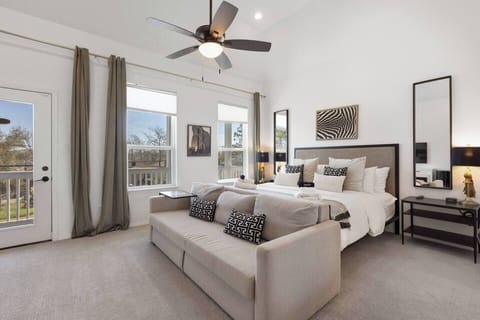 Master Suite: Elegant retreat with a king bed, stylish decor, and sunny balcony views!