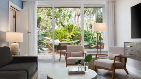 Unwind in the airy lounge with garden-facing glass doors.