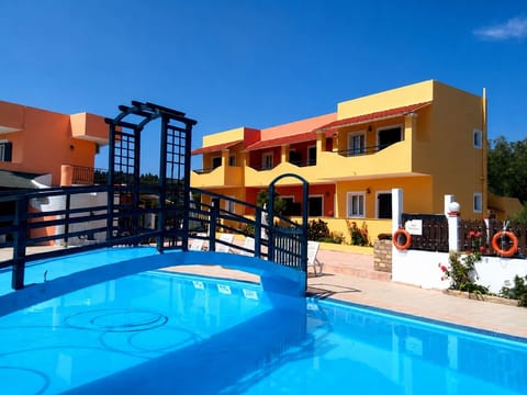 The pool sits at the heart of the property, surrounded by sun loungers and Mediterranean greenery, creating an easy rhythm between relaxing swims and afternoons exploring southern Corfu.