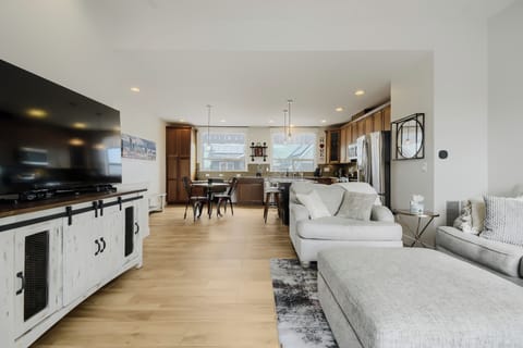 This bright open-concept space invites you to relax on plush sofas, cook in the gourmet kitchen with modern appliances, and gather at the dining table—all bathed in natural light.