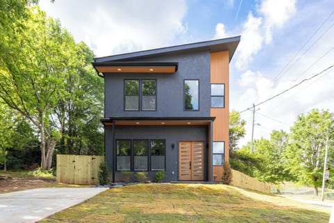 Modern architectural gem just minutes from downtown Atlanta. Sleek lines, bold contrast, and warm wood accents create a striking curb appeal that sets the tone for the stylish design found throughout this contemporary retreat.