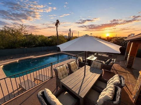 The pool is overlooked by the patio and hot tub.