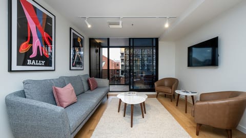 Comfortable living area with Smart TV and direct access to the private balcony.