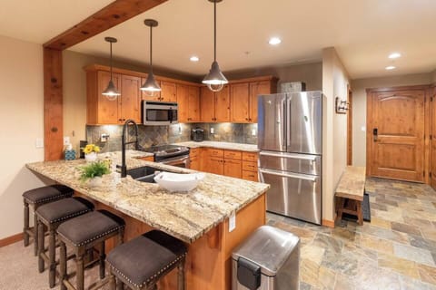 Beautiful kitchen with granite countertops, stainless steel appliances, and solid wood cabinetry! 