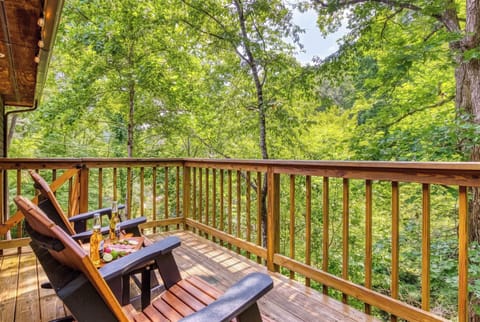 Relax on the private back porch with cozy rocking chairs, overhead string lights, and peaceful forest views. It's the perfect spot to enjoy your morning coffee or unwind with an evening drink.
