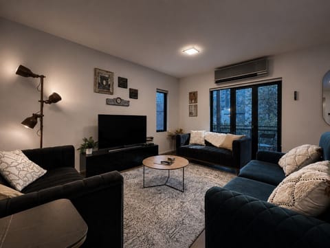 The living room has a smart HD TV, decorous reading material, and plush sofas, including a fold-out sofa bed (advance notice is required if you would like to have the sofa bed made up for your stay).