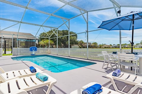 Soak up the Florida sunshine from the pool deck featuring lounge chairs, shaded seating, and beautiful waterfront views in a private screened setting.